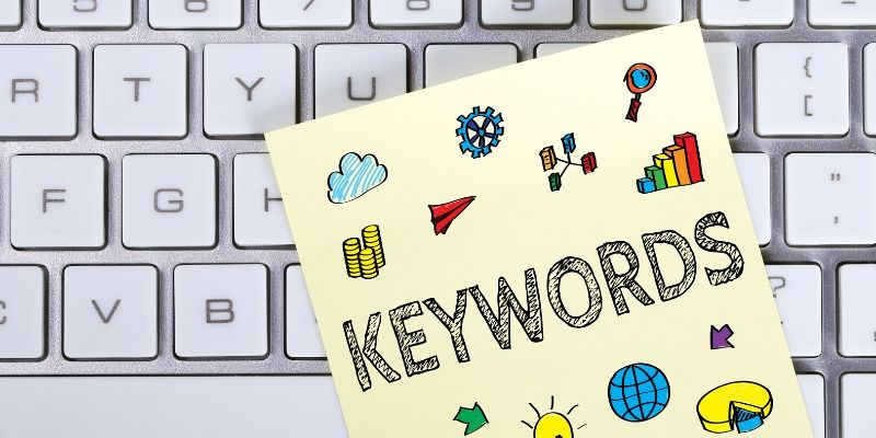 Computer Keyword has a yellow post it note with the word Keywords and icons on it