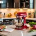 Step into a bright, organized 2024 kitchen where sunlight floods sleek marble counters topped with must-have gadgets, a vibrant red mixer, fresh vegetables, and an inviting cookbook—setting the stage for inspired modern cooking.