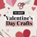 A flat lay of crafting supplies, featuring paper hearts, scissors, paintbrushes, ribbon, and a jar. The text in the center boldly reads 10 Easy Valentine’s Day Crafts. The festive color palette of red, pink, and white enhances these Valentine’s Day crafts beautifully.