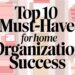 A graphic with the text Top 10 Must-Have for Home Organization Success over a background of shelves filled with storage boxes and organizers.
