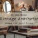 Cozy vintage living room with a leather armchair, ornate mirror, flowers in a vase, and a stack of books on a wooden table. The image contains text: 10 timeless Vintage Aesthetic ideas for your home.