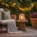 Transform your patio into a warm retreat with cozy wicker seating, soft blankets, glowing lanterns, and lush greenery—all brought together under charming string lights for an inviting outdoor escape.