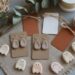 Discover inspiration for handmade crafts with this charming display of ghost-shaped clay earrings and charms, gift tags, ribbons, and dried foliage—an inviting flat lay that celebrates creative DIY projects.