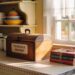 Cozy Vintage Kitchen Decor Ideas: Wooden Recipe Box, Tied Cookbooks, Copper Accents & Lace Curtains for Home Inspiration.