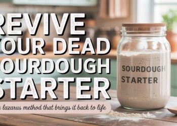 A sourdough blog jar rests on a kitchen counter next to a wooden spoon. Bold text says, Rise Again: Revive Your Dead Starter, with the caption below: The Lazarus Method for revival.